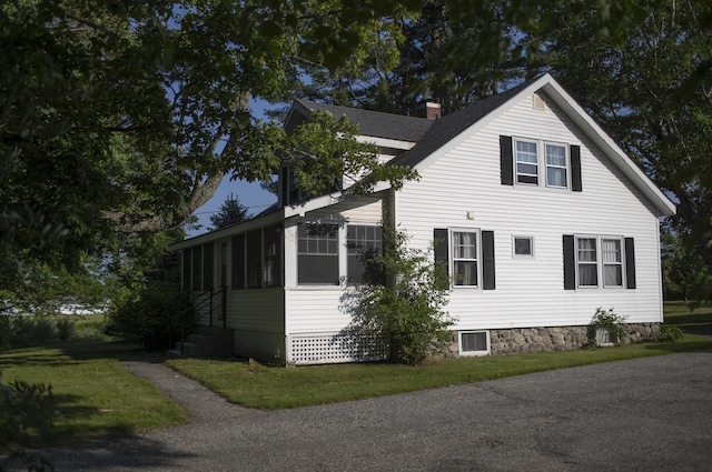 55 Ossipee Trl E, Standish, ME 04084 - view of side of property featuring a sunroom, a yard, and a chimney