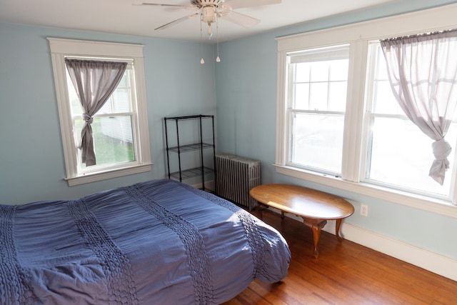 55 Ossipee Trl E, Standish, ME 04084 - bedroom with radiator, wood finished floors, and a ceiling fan