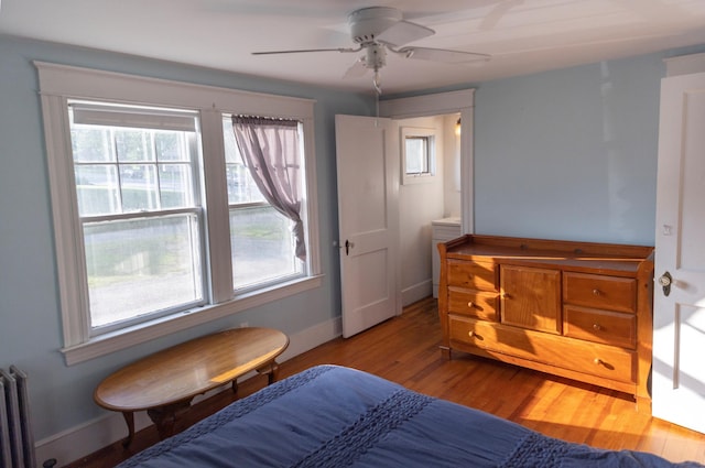 55 Ossipee Trl E, Standish, ME 04084 - bedroom with radiator, multiple windows, wood finished floors, and a ceiling fan