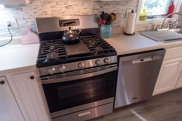 55 Ossipee Trl E, Standish, ME 04084 - kitchen with appliances with stainless steel finishes, light countertops, white cabinets, and wood finished floors