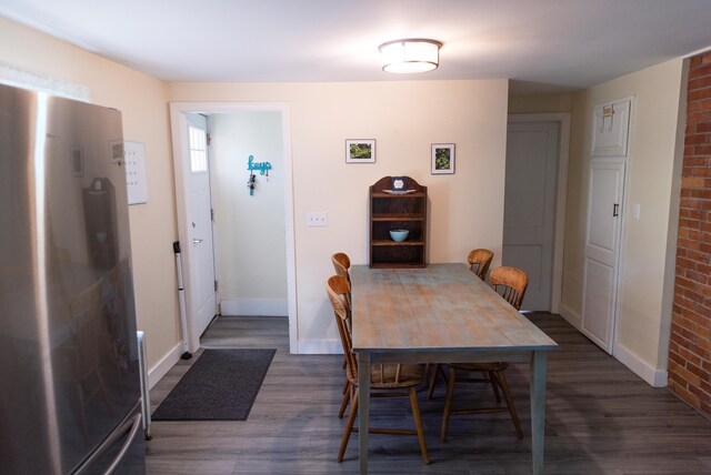 55 Ossipee Trl E, Standish, ME 04084 - dining room with dark wood-type flooring and brick wall