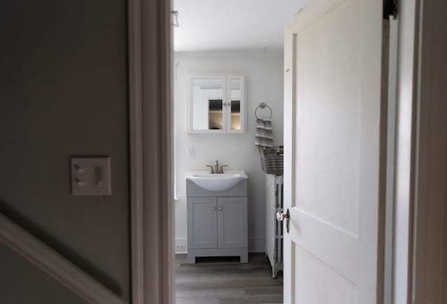 55 Ossipee Trl E, Standish, ME 04084 - bathroom featuring vanity, ornamental molding, and wood finished floors