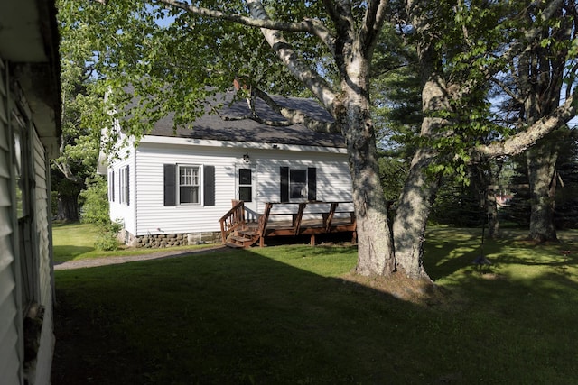 55 Ossipee Trl E, Standish, ME 04084 - view of front of property with a front yard, a deck, and roof with shingles