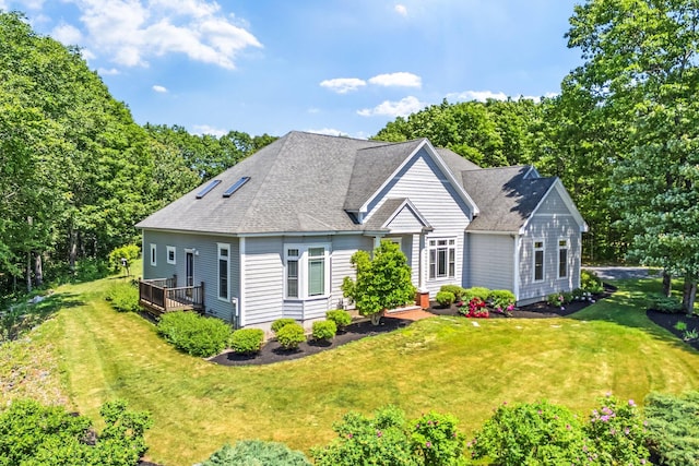 2 Summit Ln, Raymond, ME 04071 - view of front facade featuring a front yard, a deck, and roof with shingles