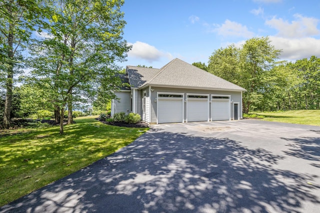 2 Summit Ln, Raymond, ME 04071 - view of side of property featuring driveway, a garage, a lawn, and a shingled roof