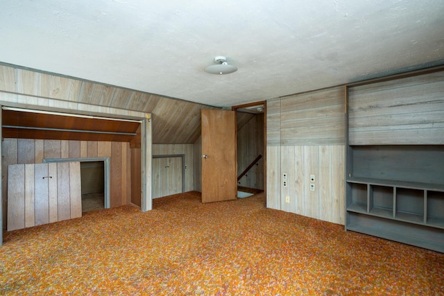 4 Sterling Rd, Kittery, ME 03904 - unfurnished bedroom featuring wood walls, carpet flooring, and vaulted ceiling