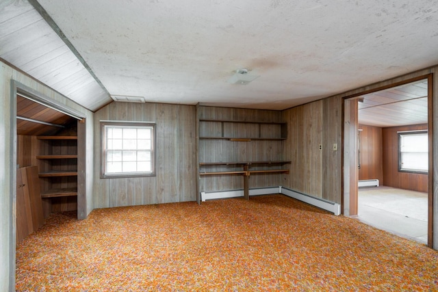 4 Sterling Rd, Kittery, ME 03904 - carpeted spare room featuring baseboard heating, wooden walls, lofted ceiling, and a textured ceiling