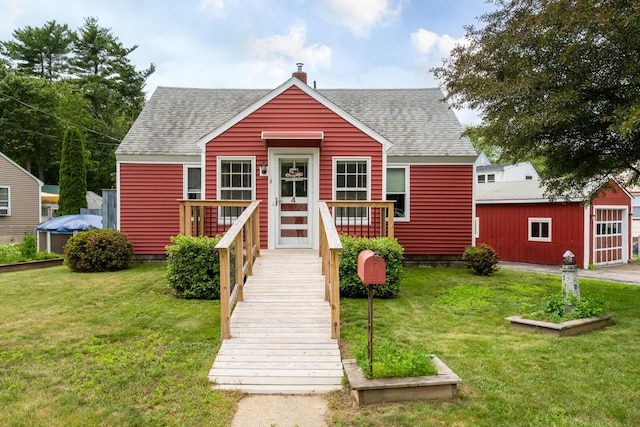 4 Sterling Rd, Kittery, ME 03904 - view of front facade with roof with shingles, a front lawn, and an outdoor structure