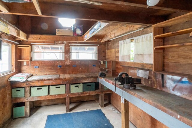 4 Sterling Rd, Kittery, ME 03904 - miscellaneous room featuring unfinished concrete flooring, plenty of natural light, and wooden walls