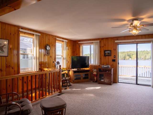 16 Hide Away Ln, Milton, NH 03851 - living room with carpet flooring, wooden walls, and ceiling fan