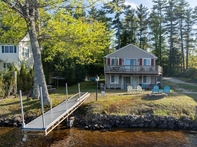 16 Hide Away Ln, Milton, NH 03851 - back of property featuring an outdoor fire pit, a lawn, and a deck with water view