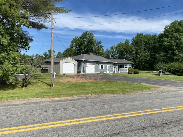 68 Stetson Rd, Newport, ME 04953 - ranch-style home featuring asphalt driveway, a front lawn, an attached garage, and a chimney