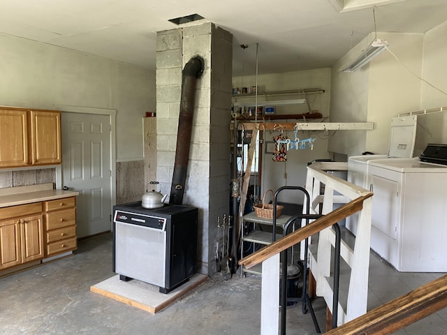68 Stetson Rd, Newport, ME 04953 - below grade area featuring washing machine and dryer and a wood stove