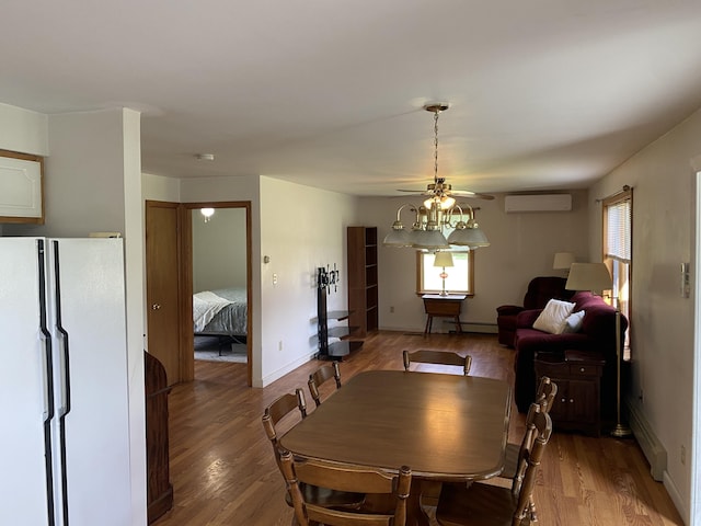 68 Stetson Rd, Newport, ME 04953 - dining area with a wall mounted air conditioner, baseboard heating, light wood-style flooring, a ceiling fan, and a baseboard heating unit