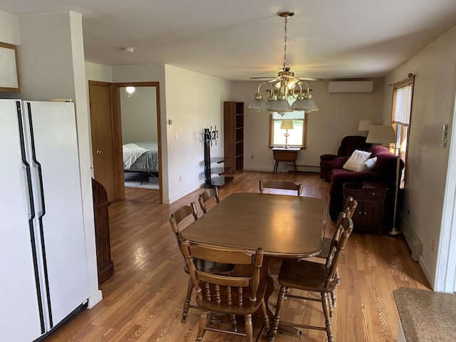 68 Stetson Rd, Newport, ME 04953 - dining area featuring an AC wall unit, light wood finished floors, and healthy amount of natural light
