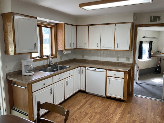 68 Stetson Rd, Newport, ME 04953 - kitchen featuring dishwasher, white cabinetry, wood finished floors, and backsplash
