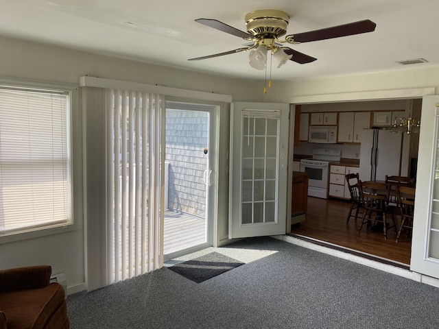 68 Stetson Rd, Newport, ME 04953 - doorway to outside with ceiling fan, healthy amount of natural light, and dark colored carpet