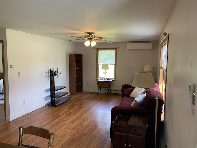 68 Stetson Rd, Newport, ME 04953 - living area featuring an AC wall unit, a ceiling fan, light wood-style floors, and baseboard heating