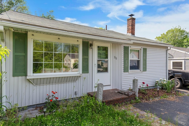96 Holm Ave, Portland, ME 04102 - view of front of property featuring board and batten siding and a chimney