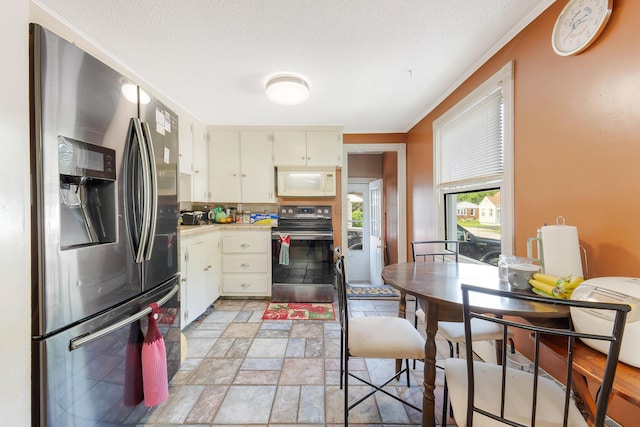 96 Holm Ave, Portland, ME 04102 - kitchen with appliances with stainless steel finishes, light countertops, stone tile flooring, and backsplash