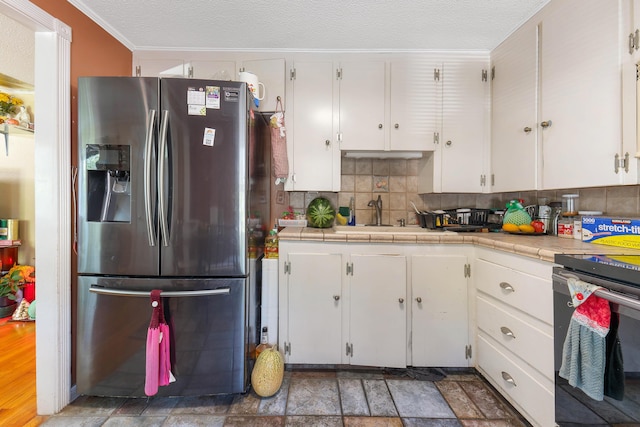 96 Holm Ave, Portland, ME 04102 - kitchen with stainless steel fridge with ice dispenser, white cabinets, tasteful backsplash, range, and ornamental molding