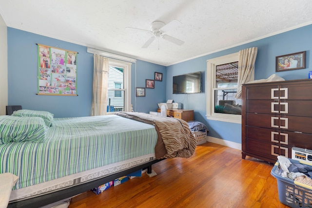 96 Holm Ave, Portland, ME 04102 - bedroom featuring wood finished floors, crown molding, a textured ceiling, and a ceiling fan