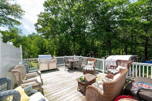 93 Bartlett Rd, Kittery, ME 03905 - wooden deck with outdoor dining area, a grill, and view of scattered trees