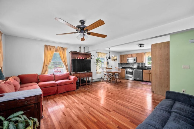 93 Bartlett Rd, Kittery, ME 03905 - living area featuring a ceiling fan, light wood finished floors, and a chandelier