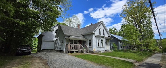 555 Depot St, Wilton, ME 04294 - view of front facade with driveway, a chimney, a shingled roof, and a front yard
