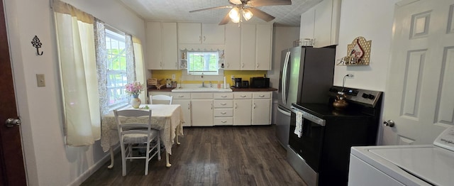 555 Depot St, Wilton, ME 04294 - kitchen with stainless steel range with electric cooktop, washer / dryer, a ceiling fan, dark wood finished floors, and white cabinetry