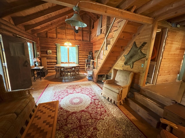 124 S Shore Dr, Rangeley Plt, ME 04970 - living room with log walls, stairway, wood finished floors, a wood ceiling with exposed beams, and high vaulted ceiling