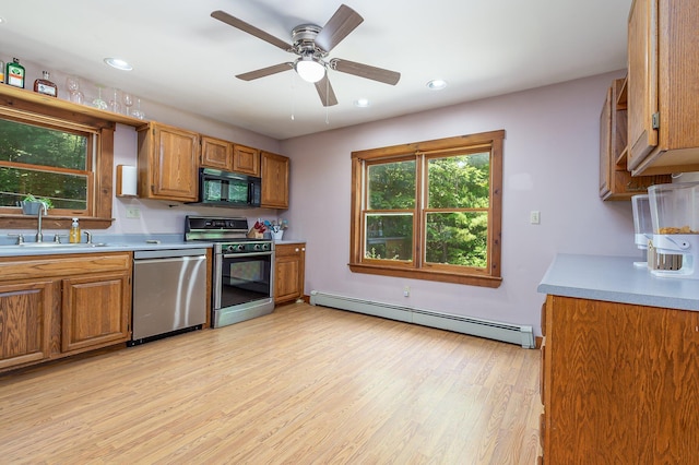 64 Pond View Dr, Otisfield, ME 04270 - kitchen featuring appliances with stainless steel finishes, baseboard heating, light countertops, brown cabinetry, and recessed lighting