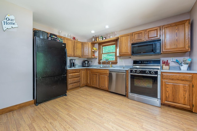 64 Pond View Dr, Otisfield, ME 04270 - kitchen featuring black appliances, light wood-style floors, light countertops, open shelves, and brown cabinets