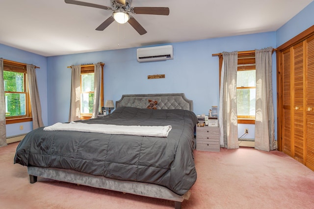 64 Pond View Dr, Otisfield, ME 04270 - carpeted bedroom with a wall unit AC, a baseboard heating unit, ceiling fan, and a closet