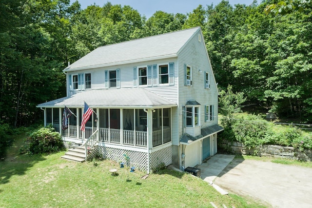 64 Pond View Dr, Otisfield, ME 04270 - view of front of property with driveway, a garage, a front lawn, and a sunroom