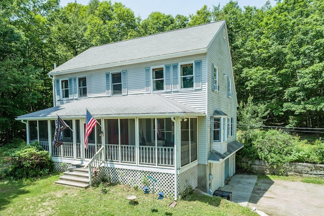 64 Pond View Dr, Otisfield, ME 04270 - view of front of house with a shingled roof, driveway, a sunroom, and a front lawn