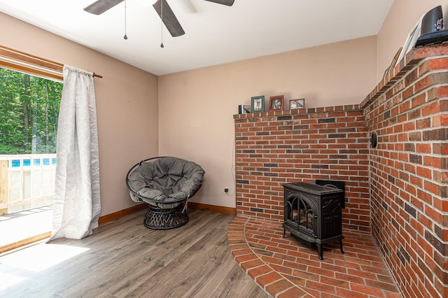64 Pond View Dr, Otisfield, ME 04270 - detailed view of ceiling fan, a wood stove, and wood finished floors