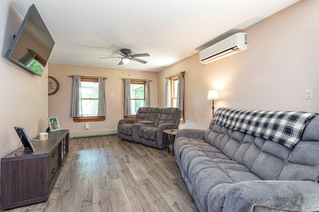 64 Pond View Dr, Otisfield, ME 04270 - living room featuring a wall unit AC, ceiling fan, wood finished floors, and a baseboard heating unit