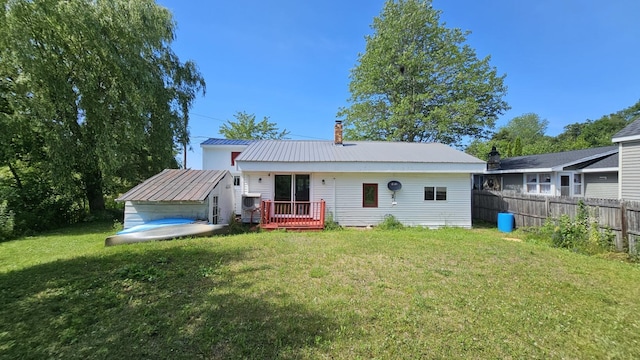 1106 S Belfast Ave, Augusta, ME 04330 - back of property with a wooden deck, a metal roof, and a chimney