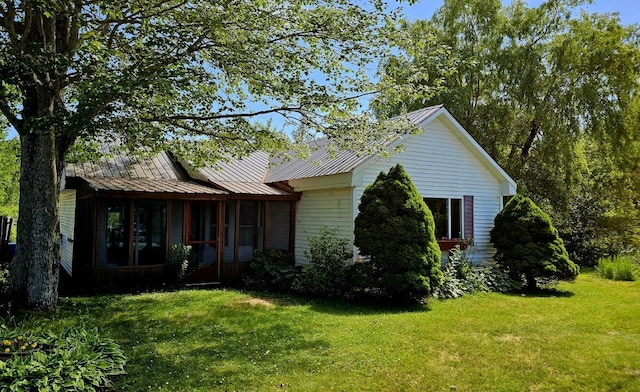 1106 S Belfast Ave, Augusta, ME 04330 - view of front of property with a front yard, a metal roof, a standing seam roof, and a sunroom