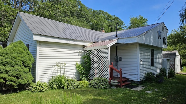 1106 S Belfast Ave, Augusta, ME 04330 - view of side of property featuring a metal roof and a lawn