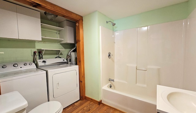 1106 S Belfast Ave, Augusta, ME 04330 - full bathroom featuring washing machine and clothes dryer, wood finished floors, and tub / shower combination