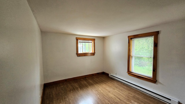 1106 S Belfast Ave, Augusta, ME 04330 - unfurnished room with a baseboard heating unit and dark wood-style flooring