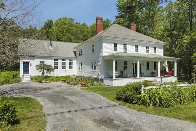 416 River Rd, Edgecomb, ME 04556 - view of front of home featuring a porch, a chimney, a shingled roof, and driveway