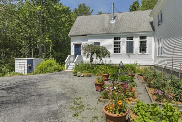 416 River Rd, Edgecomb, ME 04556 - view of front facade with a shingled roof and a storage unit