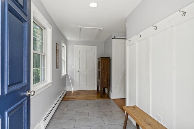 416 River Rd, Edgecomb, ME 04556 - mudroom featuring a baseboard heating unit, light tile patterned flooring, and attic access