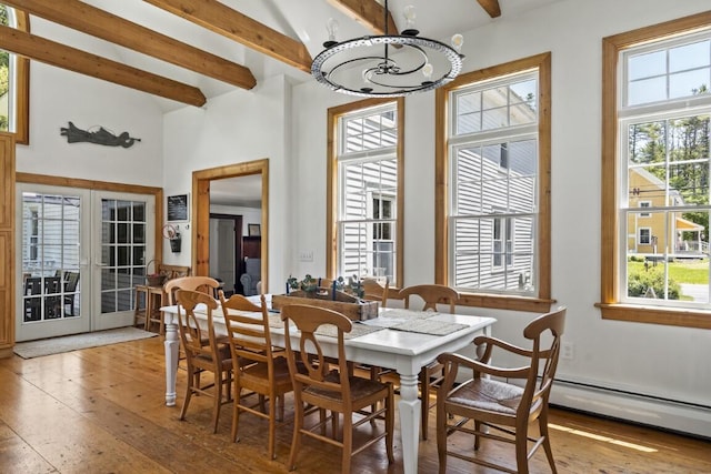 416 River Rd, Edgecomb, ME 04556 - dining space with beamed ceiling, light wood finished floors, a chandelier, plenty of natural light, and high vaulted ceiling