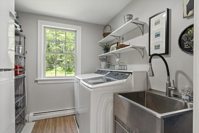 416 River Rd, Edgecomb, ME 04556 - laundry area with a baseboard heating unit, washing machine and clothes dryer, and light tile patterned floors