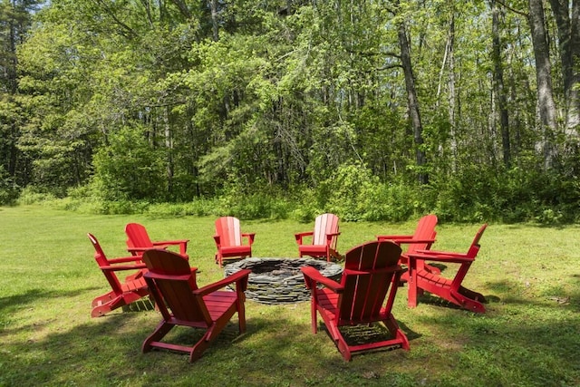 416 River Rd, Edgecomb, ME 04556 - view of jungle gym with an outdoor fire pit, a yard, and a view of trees
