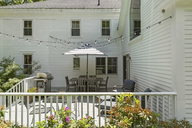 416 River Rd, Edgecomb, ME 04556 - rear view of house with roof with shingles, a wooden deck, and outdoor dining area